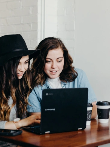 friends looking laptop