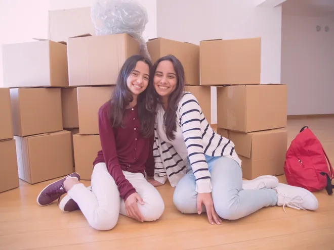 friends with boxes behind